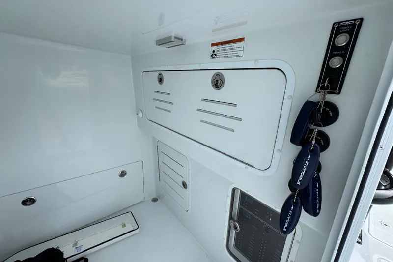Slide: The Image of 2026 Invincible 38 Catamaran interior with control panel and storage compartments. - 26