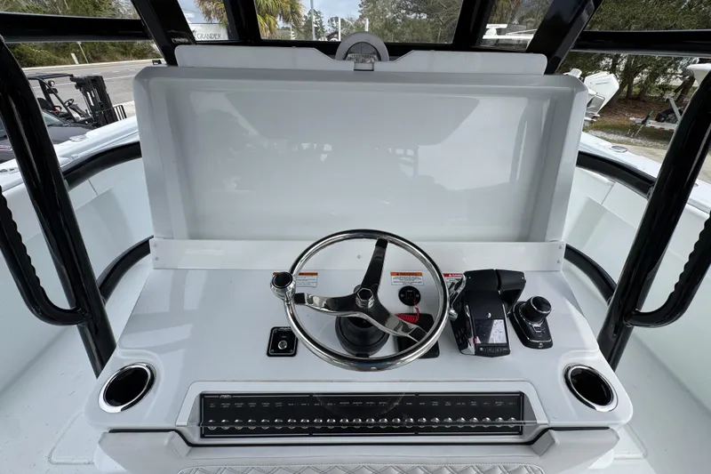 Slide: The Image of Steering console of 2026 Invincible 38 Catamaran with modern controls and sleek design. - 35