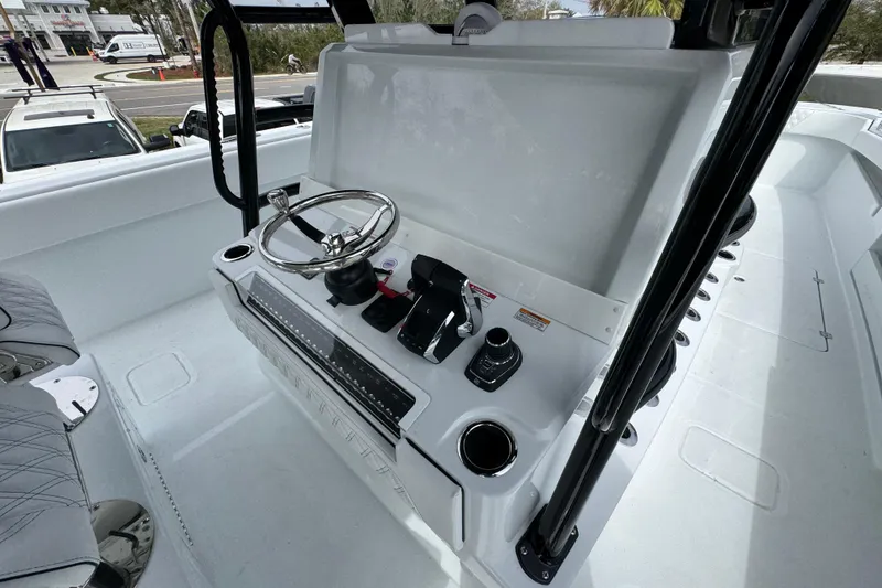 Slide: The Image of 2026 Invincible 38 Catamaran helm with steering wheel and controls, sleek modern design. - 37