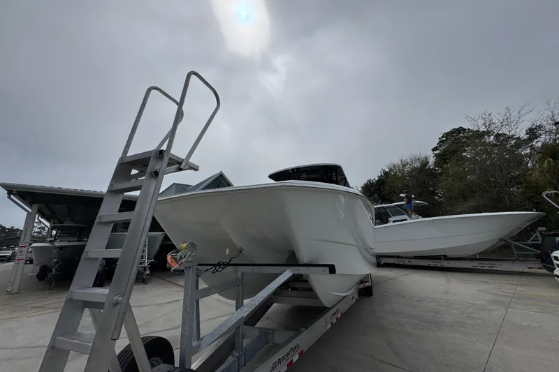 Slide: The Image of 2026 Invincible 38 Catamaran on trailer under cloudy sky. - 4