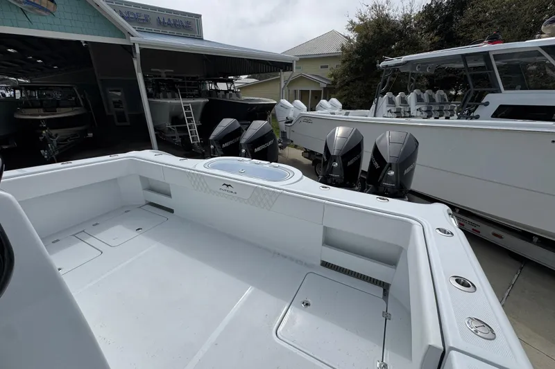 Slide: The Image of 2026 Invincible 38 Catamaran with powerful Mercury outboard engines at a marina. - 43