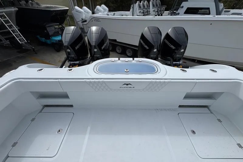Slide: The Image of 2026 Invincible 38 Catamaran with four Mercury outboard engines, sleek design. - 44