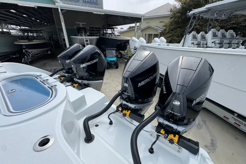 Slide: The Image of 2026 Invincible 38 Catamaran with triple Mercury outboard engines at a marina. - 46
