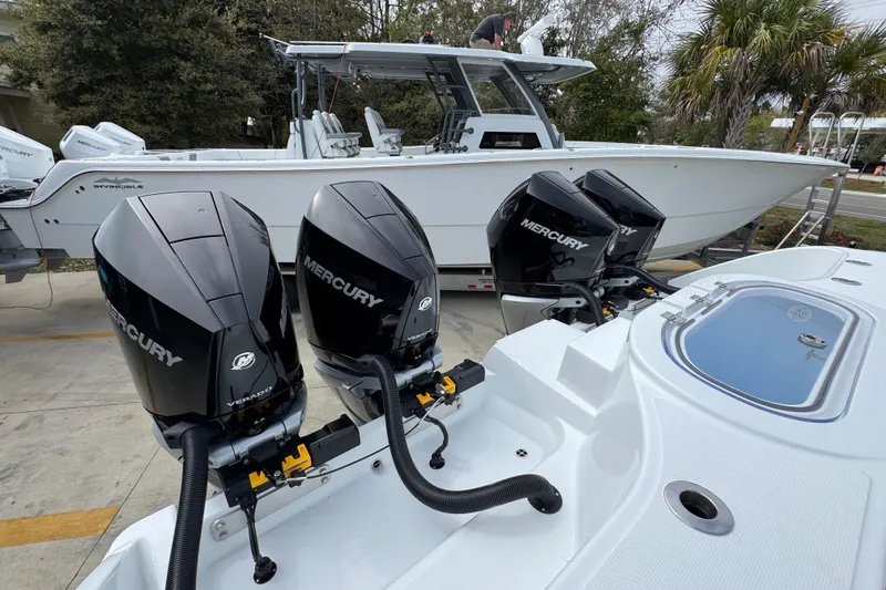 Slide: The Image of 2026 Invincible 38 Catamaran with Mercury outboard engines, docked outdoors. - 47