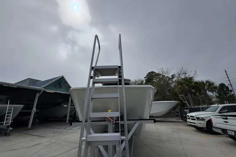 Slide: The Image of 2026 Invincible 38 Catamaran on trailer under cloudy sky, parked near vehicles. - 5