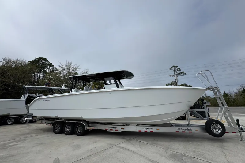 Slide: The Image of 2026 Invincible 38 Catamaran on trailer, parked outdoors, side view. - 8