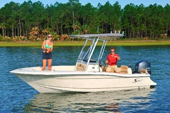 Slide: The Image of Manufacturer Provided Image: 2023 Scout 195 Sportfish boat on a lake with two people fishing. - 10