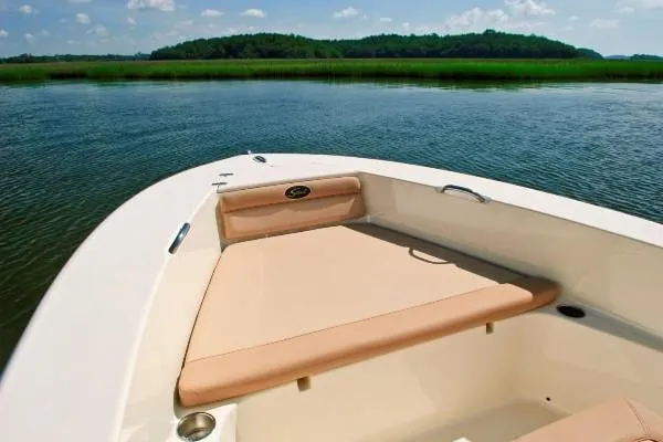 Slide: The Image of Manufacturer Provided Image: 2023 Scout 195 Sportfish boat on calm water with scenic background. - 11