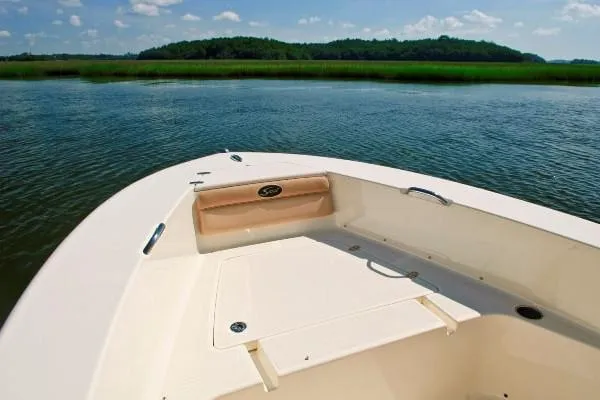 Slide: The Image of Manufacturer Provided Image: 2023 Scout 195 Sportfish boat on calm water with scenic background. - 12