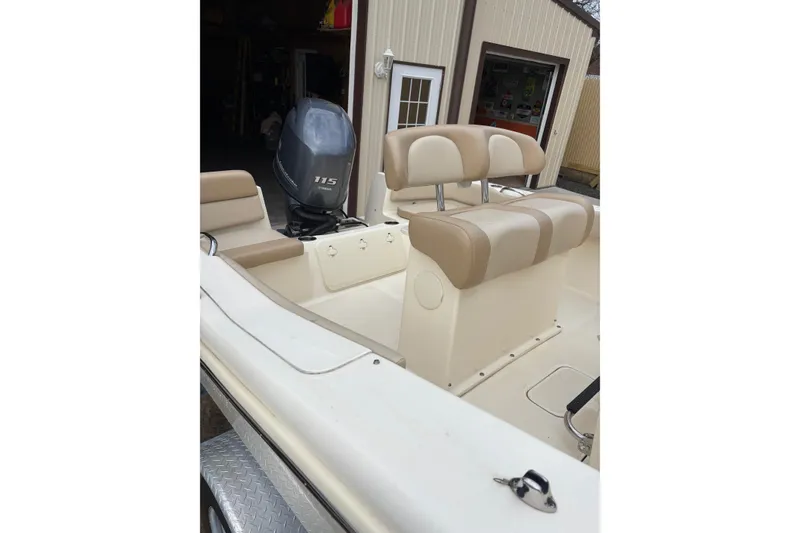 Slide: The Image of 2023 Scout 195 Sportfish boat interior with Yamaha 115 engine, beige seating. - 2