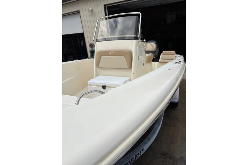 Slide: The Image of 2023 Scout 195 Sportfish boat with sleek design and beige interior. - 3
