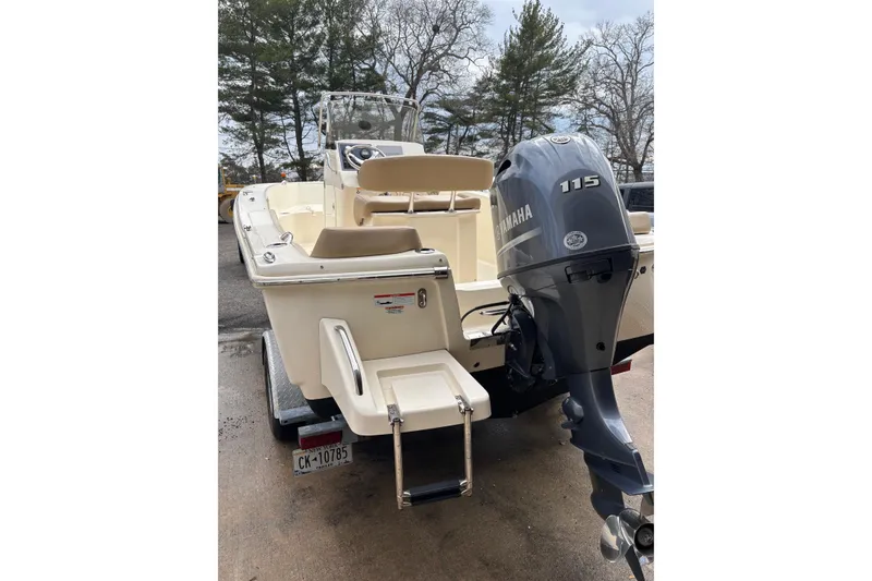 Slide: The Image of 2023 Scout 195 Sportfish boat with Yamaha 115 engine, parked on trailer. - 4