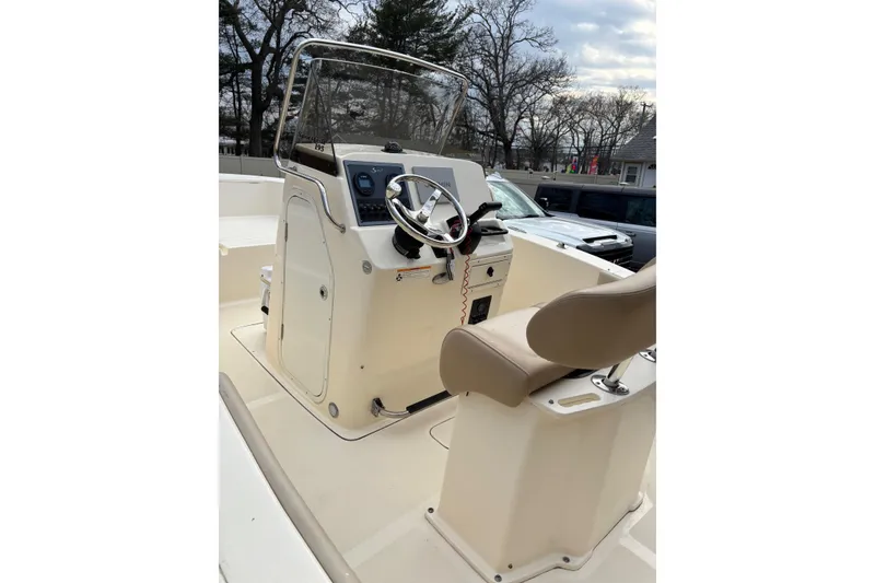 Slide: The Image of 2023 Scout 195 Sportfish boat interior with steering console and seat. - 5