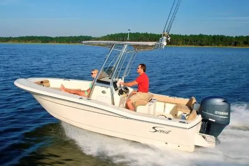 Slide: The Image of Manufacturer Provided Image: 2023 Scout 195 Sportfish boat cruising on a lake. - 7