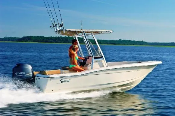 Slide: The Image of Manufacturer Provided Image: 2023 Scout 195 Sportfish boat cruising on a lake with two passengers. - 8