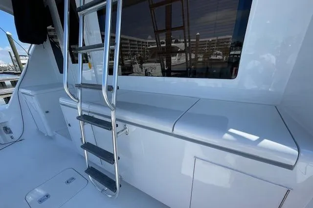 Slide: The Image of 2002 Hatteras 55 Convertible yacht deck with ladder and storage compartments. - 13