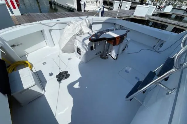 Slide: The Image of 2002 Hatteras 55 Convertible yacht deck with fishing chair and equipment. - 15