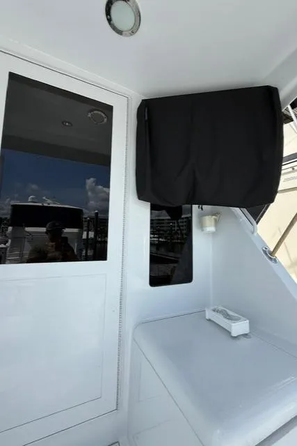 Slide: The Image of 2002 Hatteras 55 Convertible yacht interior with sleek white design and modern features. - 20