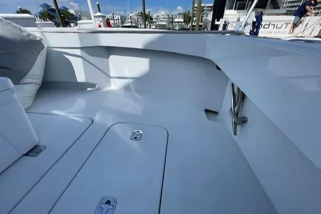 Slide: The Image of 2002 Hatteras 55 Convertible yacht deck with sleek, white finish and storage compartments. - 22