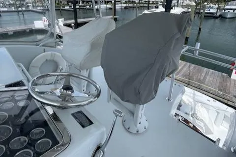 Slide: The Image of Helm of 2002 Hatteras 55 Convertible yacht with covered seats and steering wheel. - 24
