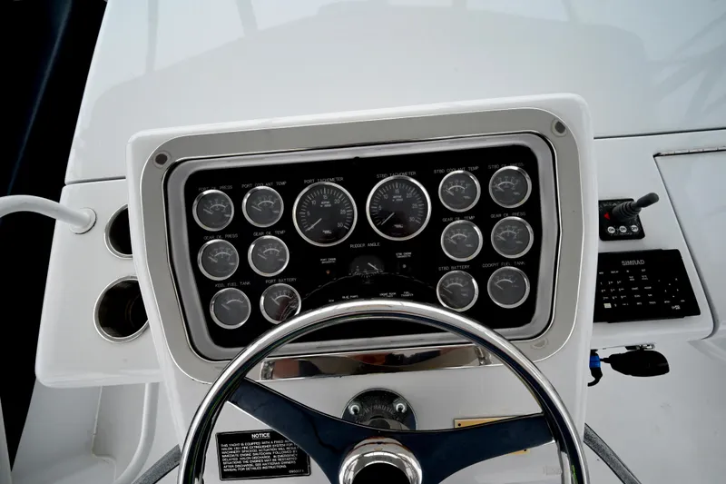 Slide: The Image of Control panel of 2002 Hatteras 55 Convertible yacht with gauges and steering wheel. - 25