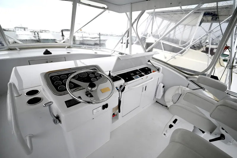 Slide: The Image of Helm of 2002 Hatteras 55 Convertible yacht with steering wheel and control panel. - 26