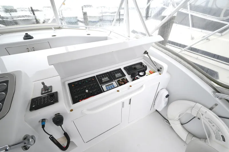 Slide: The Image of Helm station of 2002 Hatteras 55 Convertible yacht with navigation controls and equipment. - 27