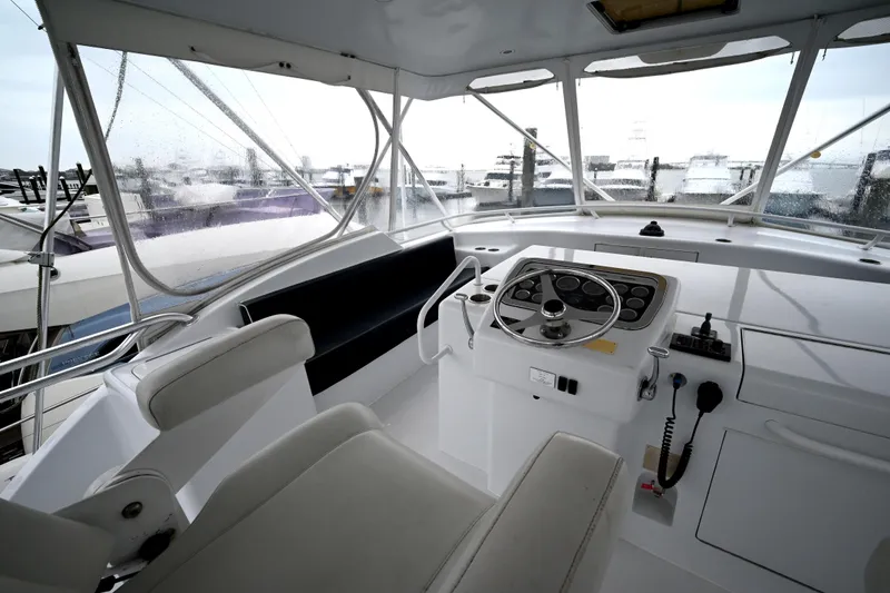 Slide: The Image of Helm of 2002 Hatteras 55 Convertible yacht with steering wheel and controls. - 29