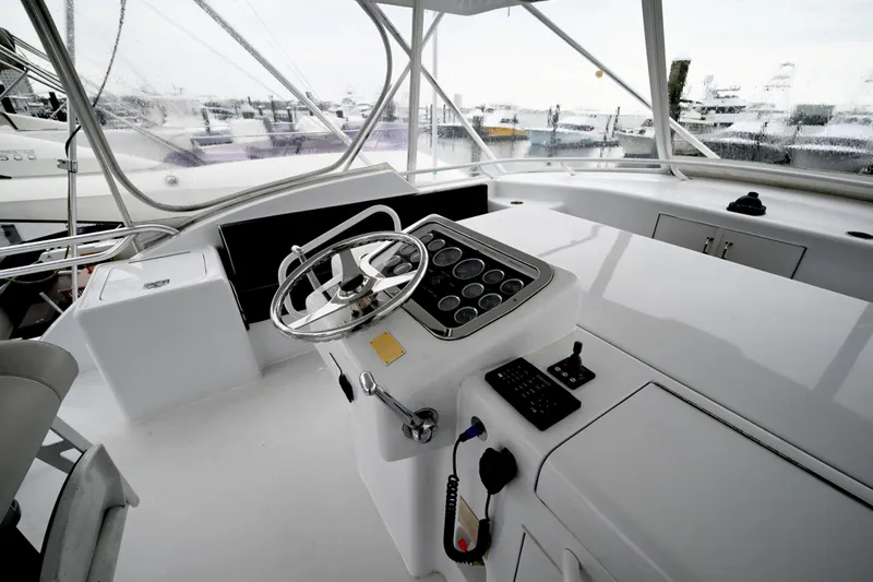 Slide: The Image of Helm of 2002 Hatteras 55 Convertible yacht with steering wheel and control panel. - 31