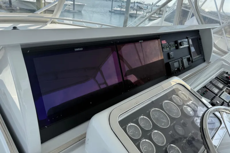 Slide: The Image of Control panel of a 2002 Hatteras 55 Convertible yacht with navigation screens. - 33