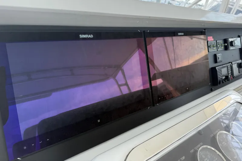 Slide: The Image of Control panel of a 2002 Hatteras 55 Convertible yacht with Simrad displays. - 34