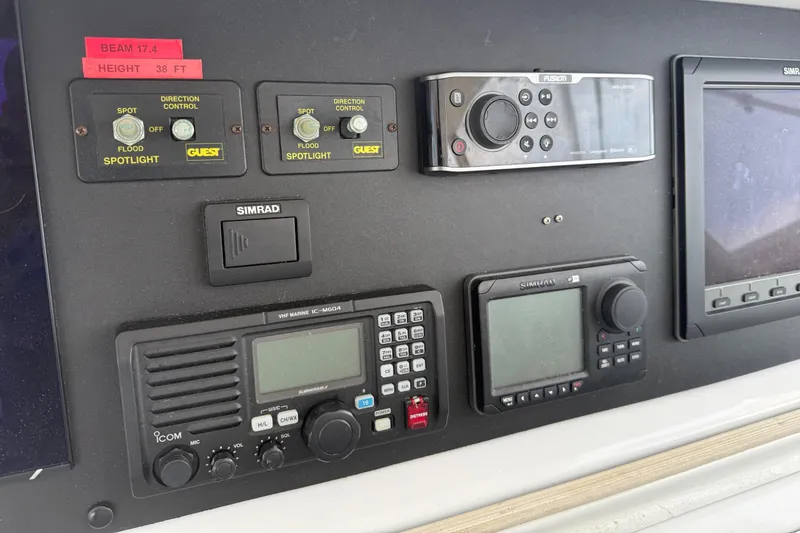 Slide: The Image of Control panel of a 2002 Hatteras 55 Convertible yacht with navigation and communication equipment. - 36