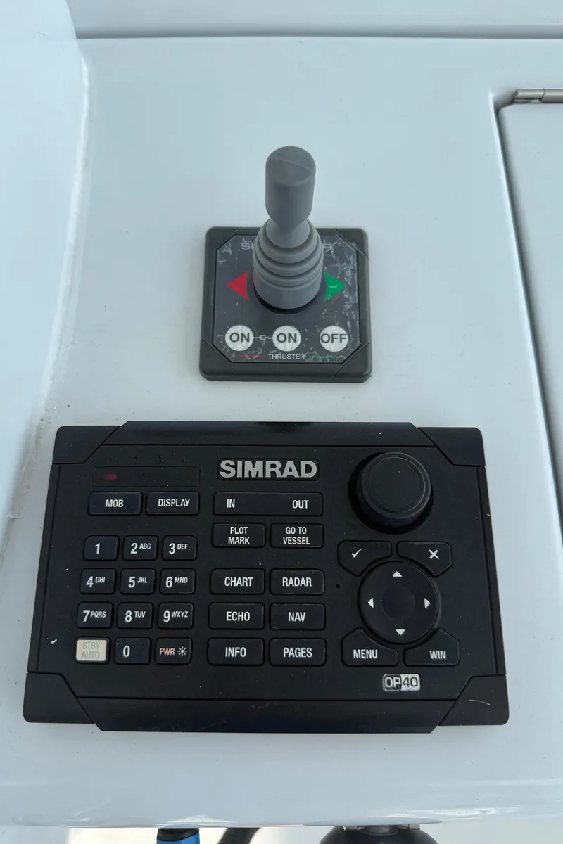Slide: The Image of Control panel of a 2002 Hatteras 55 Convertible with Simrad navigation system. - 37