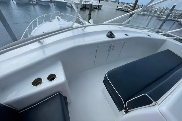 Slide: The Image of 2002 Hatteras 55 Convertible yacht deck with seating and cup holders. - 38