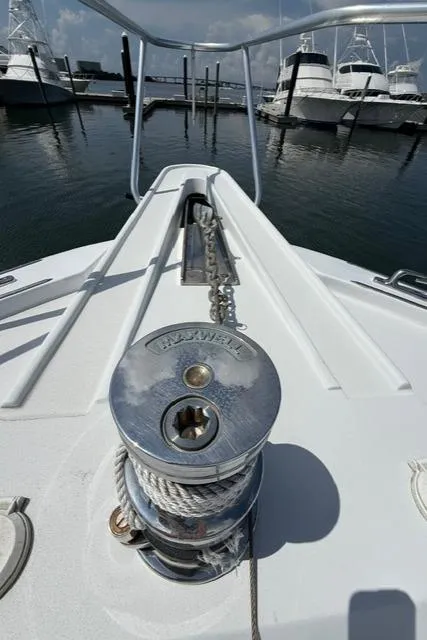 Slide: The Image of Bow of 2002 Hatteras 55 Convertible yacht with anchor windlass in marina. - 40