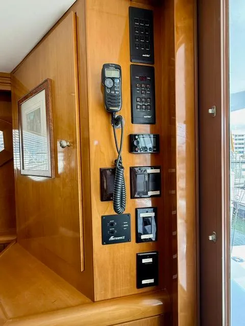 Slide: The Image of Control panel on 2002 Hatteras 55 Convertible yacht with communication and navigation equipment. - 42