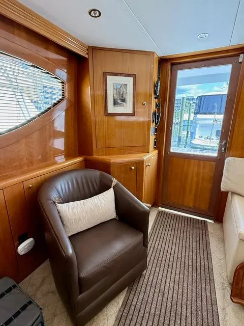 Slide: The Image of Interior of 2002 Hatteras 55 Convertible yacht with leather chair and wooden accents. - 44