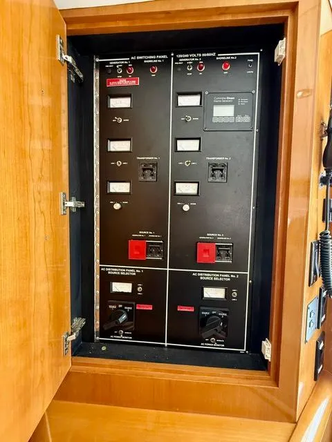 Slide: The Image of Electrical panel inside a 2002 Hatteras 55 Convertible yacht, featuring switches and controls. - 45