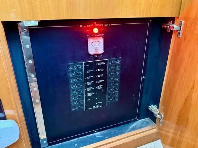 Slide: The Image of Electrical panel inside 2002 Hatteras 55 Convertible yacht, featuring battery condition meter. - 46