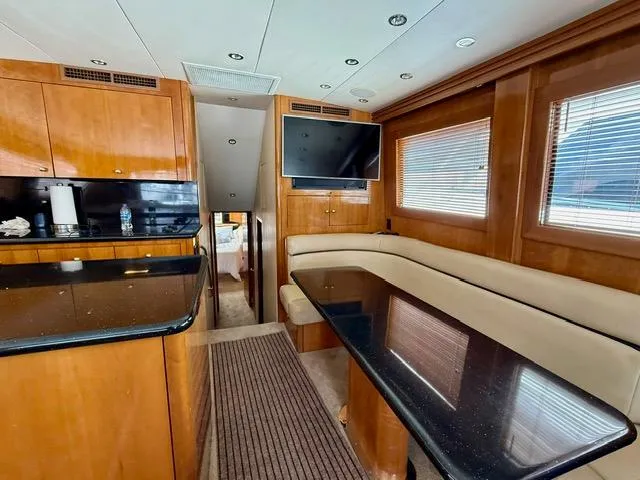 Slide: The Image of Interior of 2002 Hatteras 55 Convertible yacht with modern kitchen and seating area. - 49