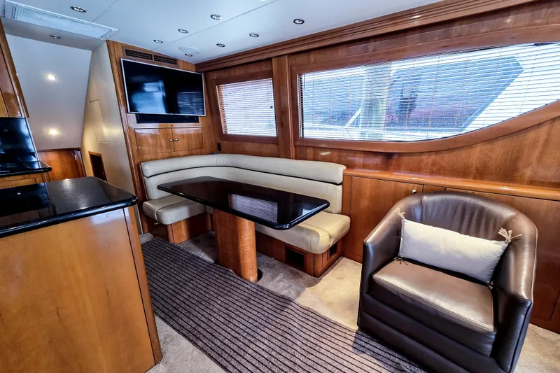Slide: The Image of Luxurious interior of 2002 Hatteras 55 Convertible yacht with seating and TV. - 50