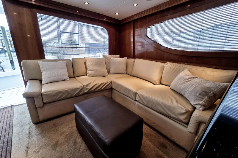 Slide: The Image of Luxurious interior of 2002 Hatteras 55 Convertible yacht with plush seating and elegant wood paneling. - 51