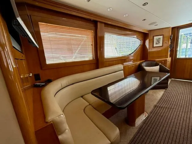 Slide: The Image of Luxurious interior of 2002 Hatteras 55 Convertible yacht with elegant seating and wooden accents. - 52