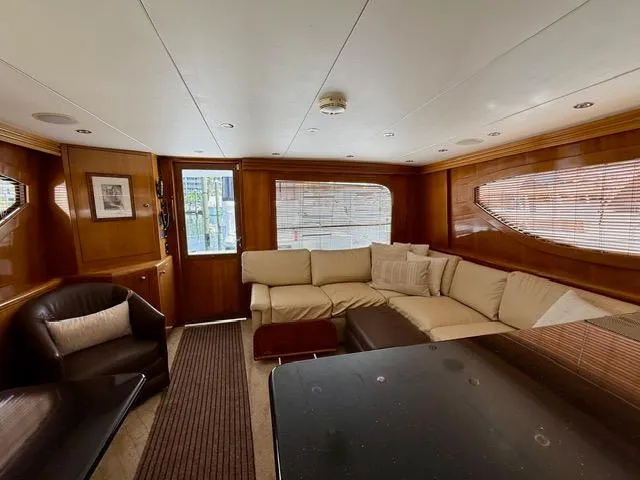 Slide: The Image of Luxurious interior of 2002 Hatteras 55 Convertible yacht with plush seating and elegant wood finishes. - 53