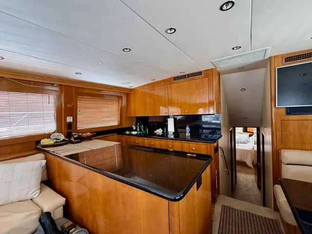 Slide: The Image of Interior of 2002 Hatteras 55 Convertible yacht with modern kitchen and cozy seating area. - 54
