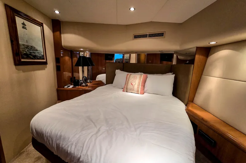 Slide: The Image of Luxurious bedroom interior of 2002 Hatteras 55 Convertible yacht with elegant decor. - 61