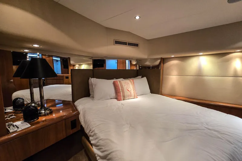 Slide: The Image of Luxurious bedroom interior of 2002 Hatteras 55 Convertible yacht with elegant lighting. - 62