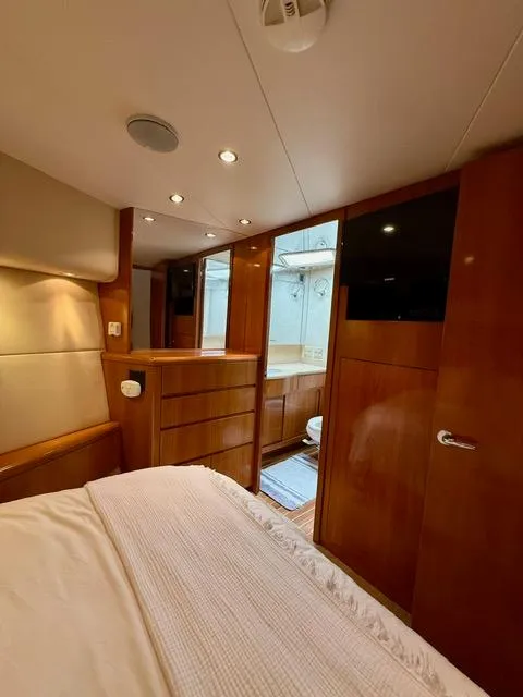 Slide: The Image of Luxurious cabin interior of 2002 Hatteras 55 Convertible yacht with wood finishes. - 63