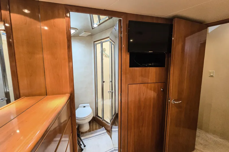 Slide: The Image of Interior of 2002 Hatteras 55 Convertible yacht with bathroom and wooden cabinetry. - 64