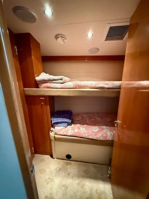Slide: The Image of Bunk beds in 2002 Hatteras 55 Convertible yacht cabin with wood paneling. - 66